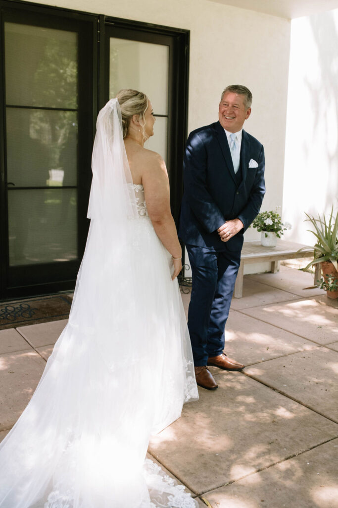 bride and her dad emotional during their first look