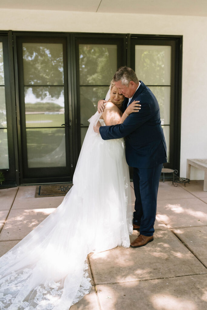 bride and her dad hugging before the wedding ceremony