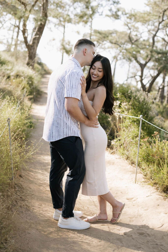 fiance kissing his fiance on the cheek 