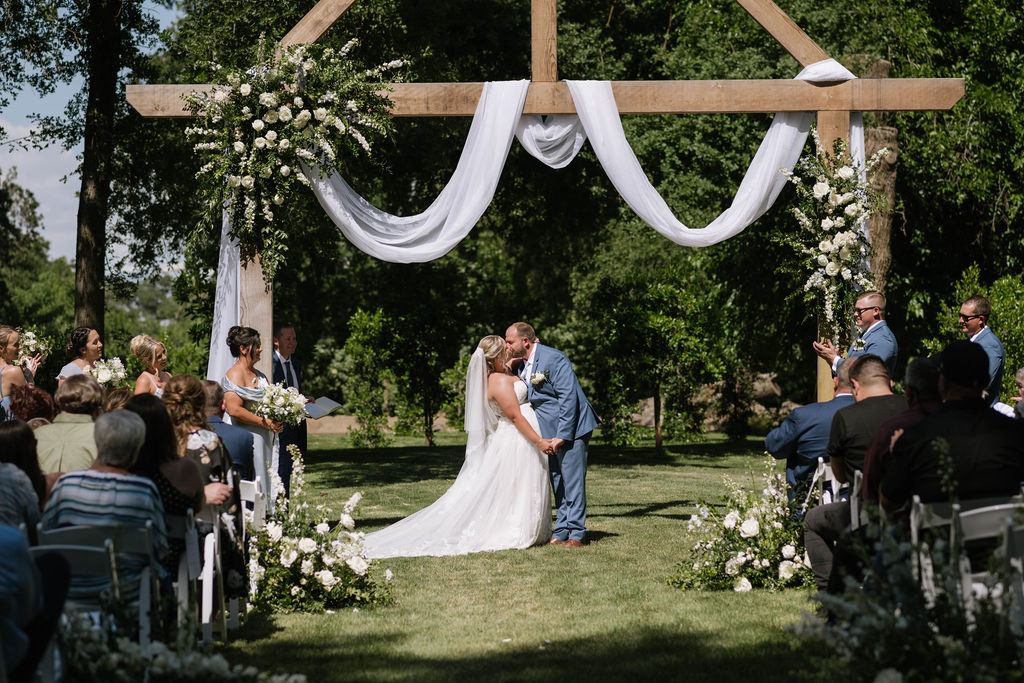 bride and groom kissing after their wedding ceremony 