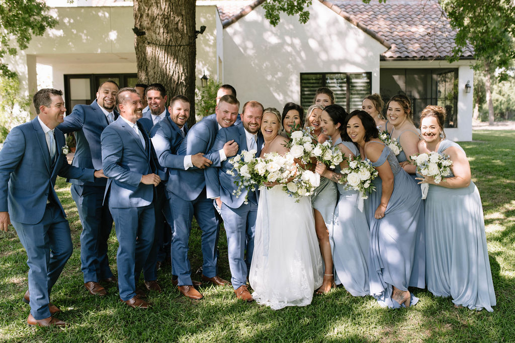 cute picture of the bride and groom with their friends at the intimate garden wedding 