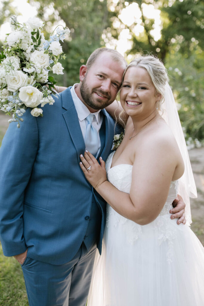 bride and groom smiling at the camera