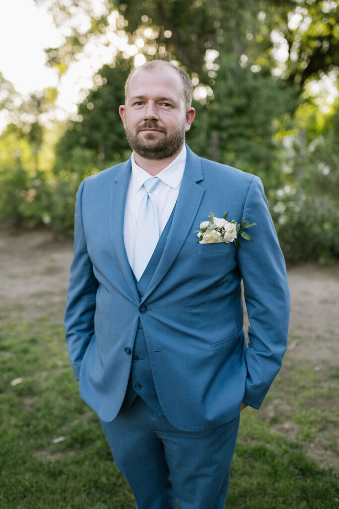 portrait of the groom at his intimate garden wedding