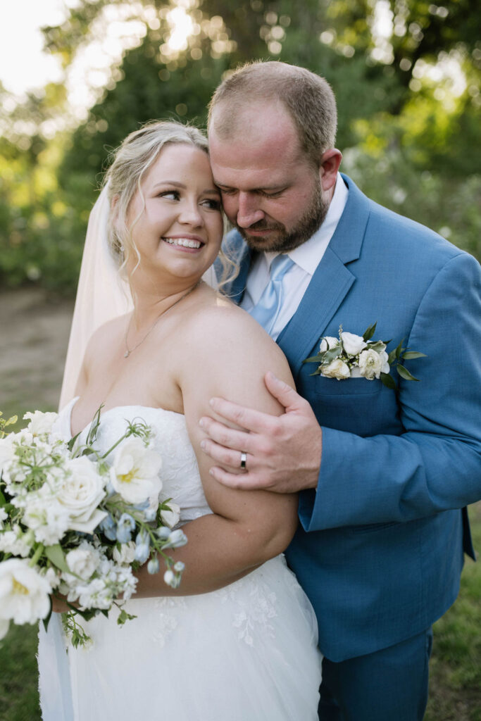 groom kissing the bride on the forehead 