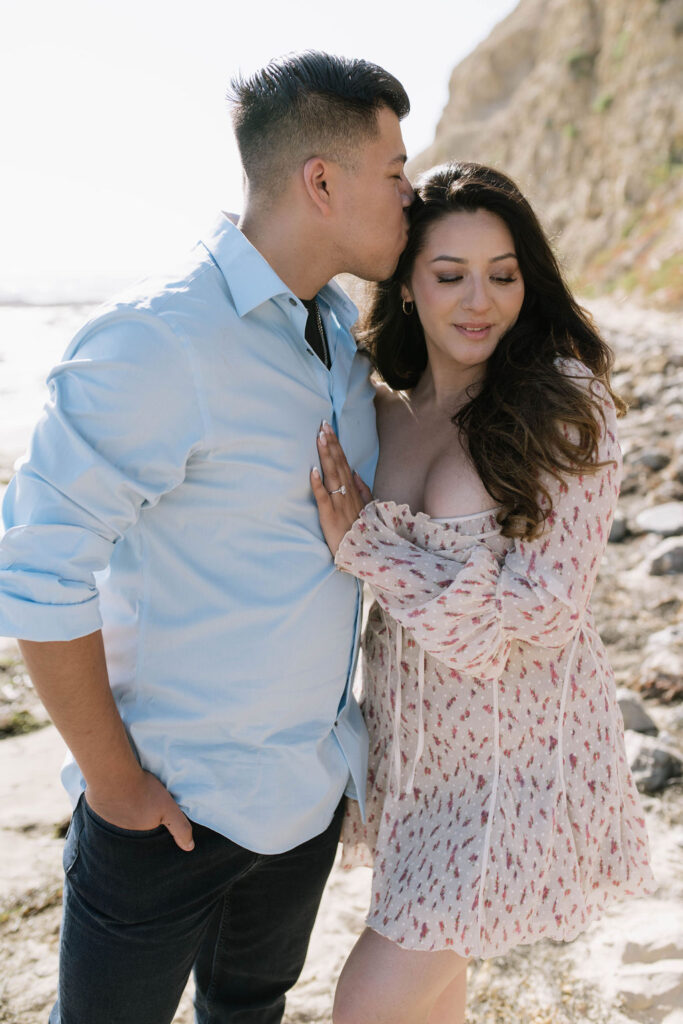 fiance kissing his fiance on the forehead 