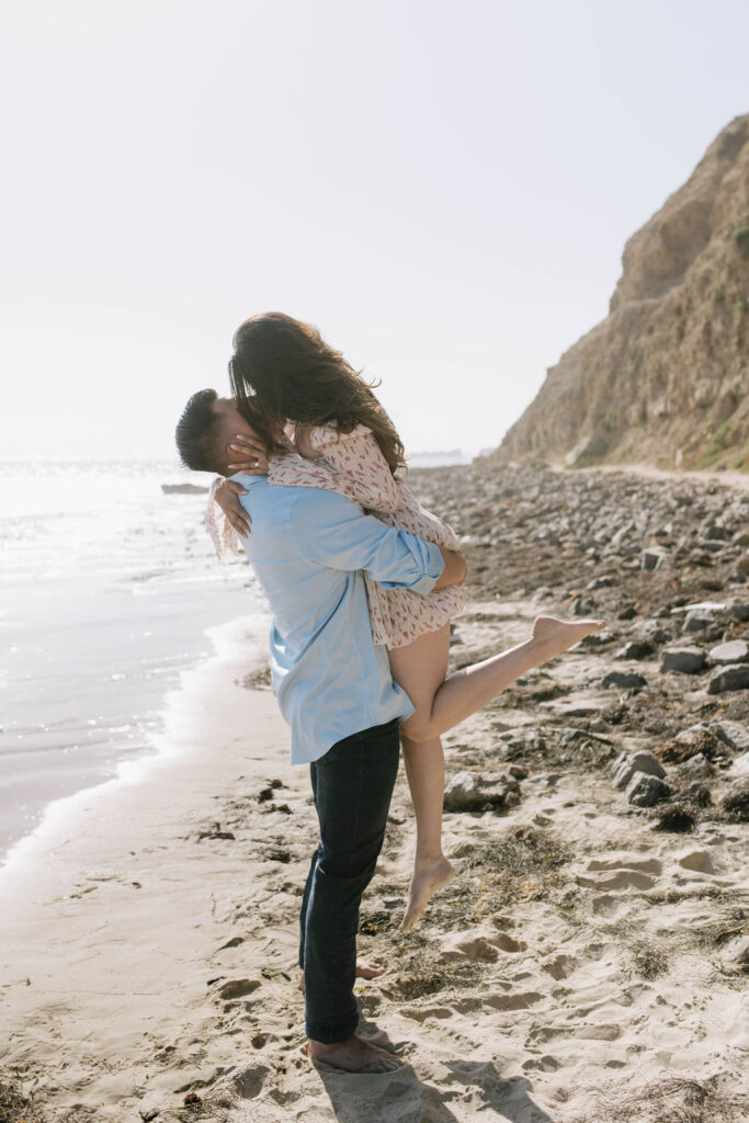 newly engaged couple kissing during their engagement photoshoot 