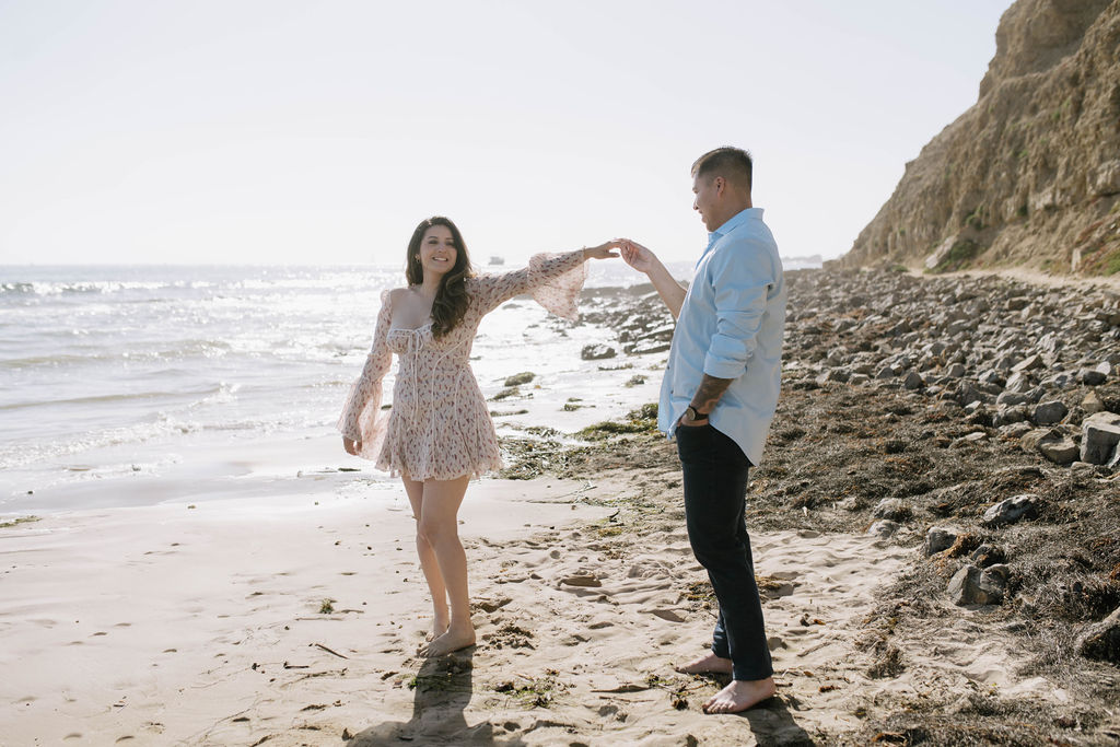 couple dancing at their romantic beach engagement session