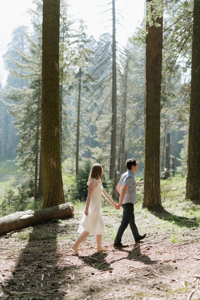 couple holding hands walking during their engagement session