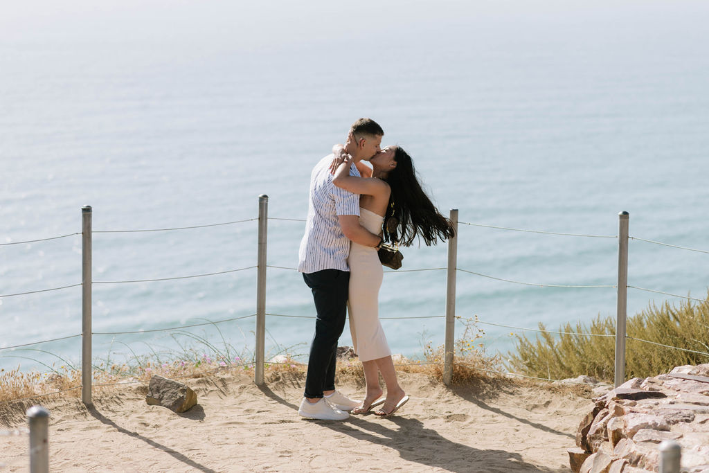 couple kissing at their engagement session at Guy Fleming Trail