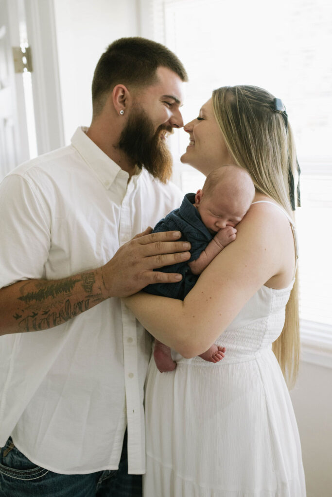 parents smiling at each other during their photoshoot 