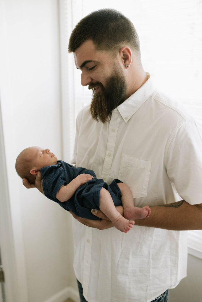 dad holding his newborn baby