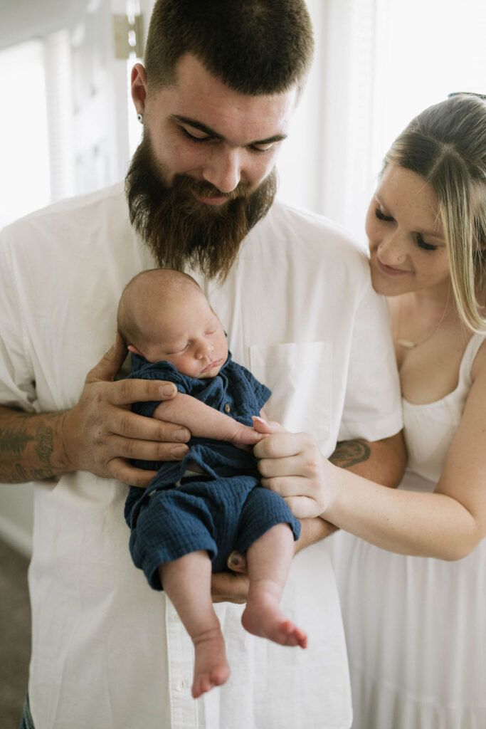 mom and dad holding their baby 