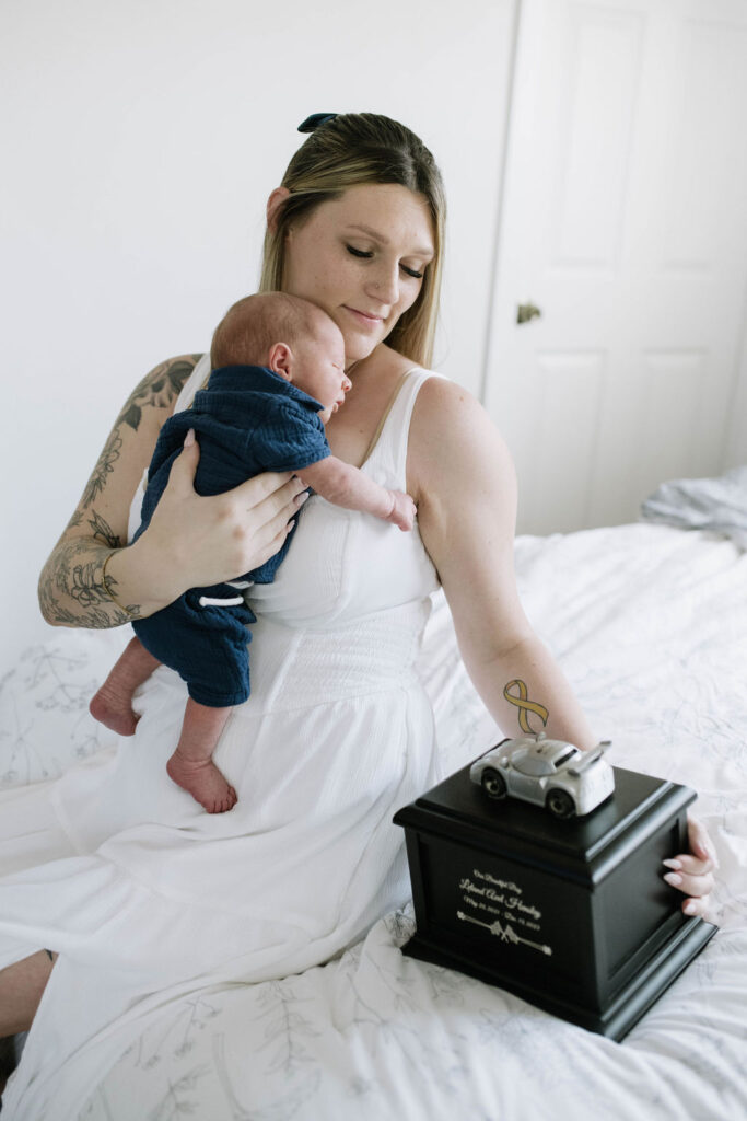 mom holding her newborn baby during their family photoshoot