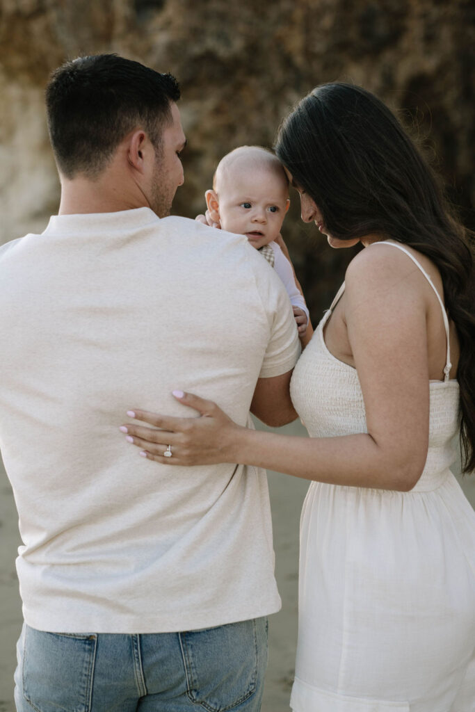 mom and dad holding their baby during their photoshoot 