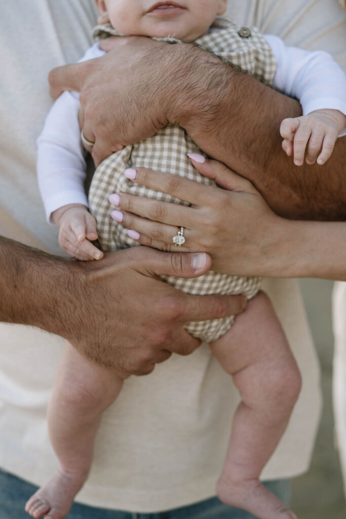 parents holding their newborn baby